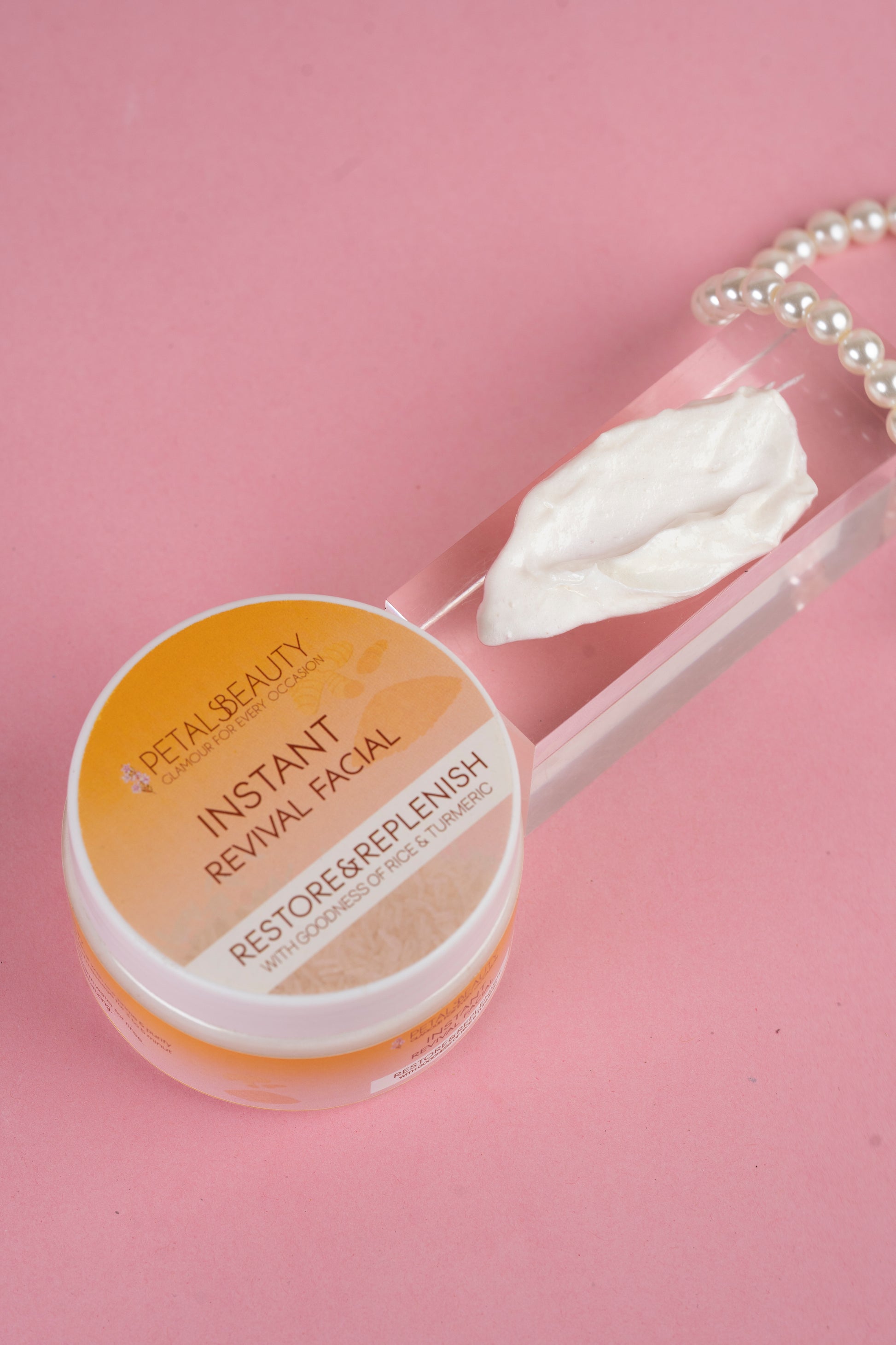 Instant glow revial facial jar with pink background and pearls aesthetic theme.